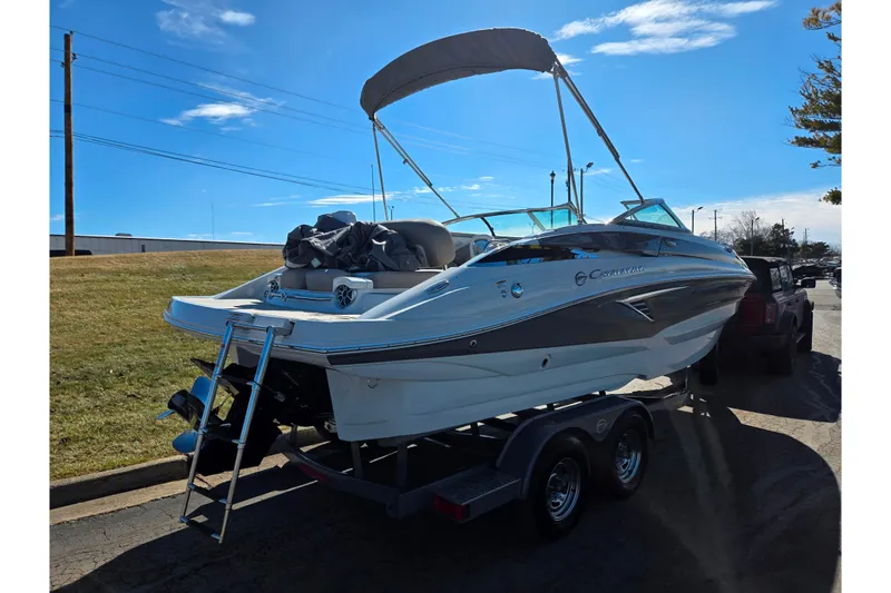 Slide: The Image of 2020 Crownline Eclipse E235 boat on trailer under clear blue sky. - 3