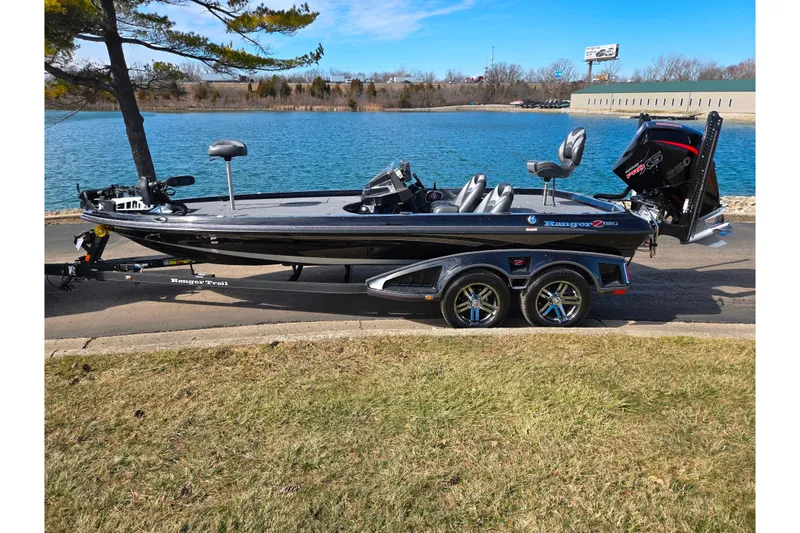 Slide: The Image of 2021 Ranger Z521L boat parked by a scenic lake on a sunny day. - 10