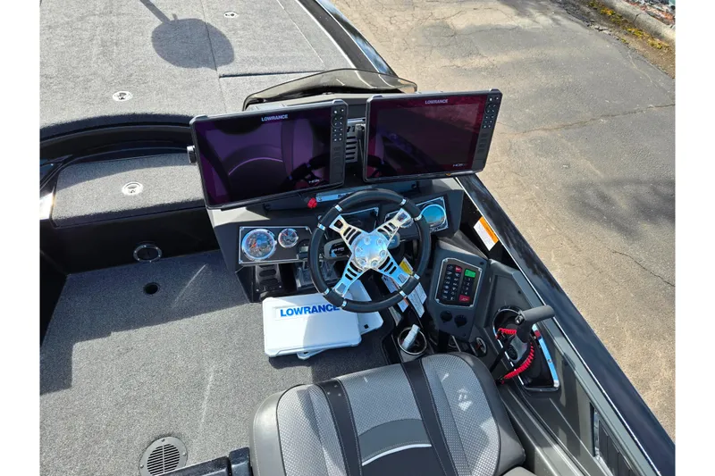 Slide: The Image of 2021 Ranger Z521L boat cockpit with dual Lowrance displays and modern steering controls. - 12
