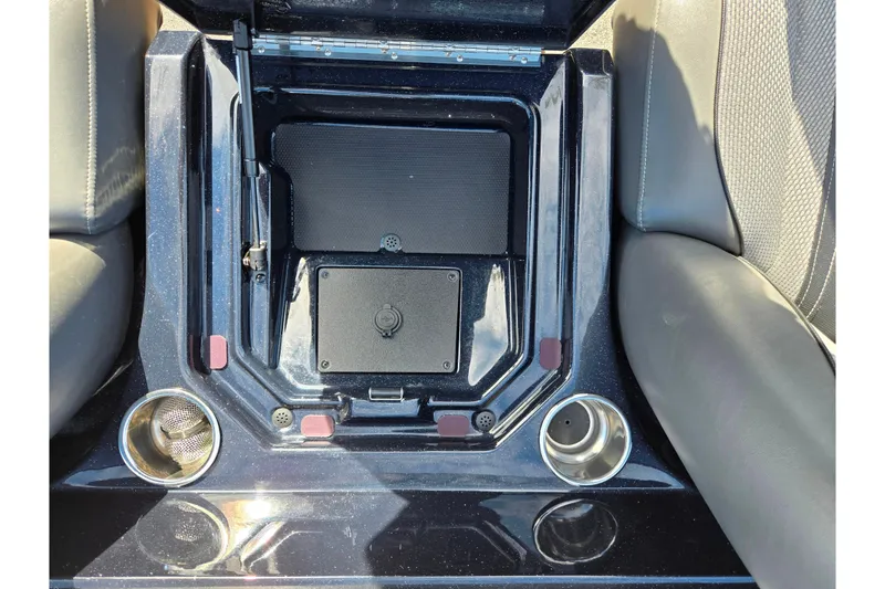 Slide: The Image of 2021 Ranger Z521L boat interior with storage compartment and cup holders. - 21