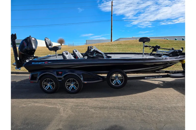 Slide: The Image of 2021 Ranger Z521L boat on trailer, parked outdoors under blue sky. - 4