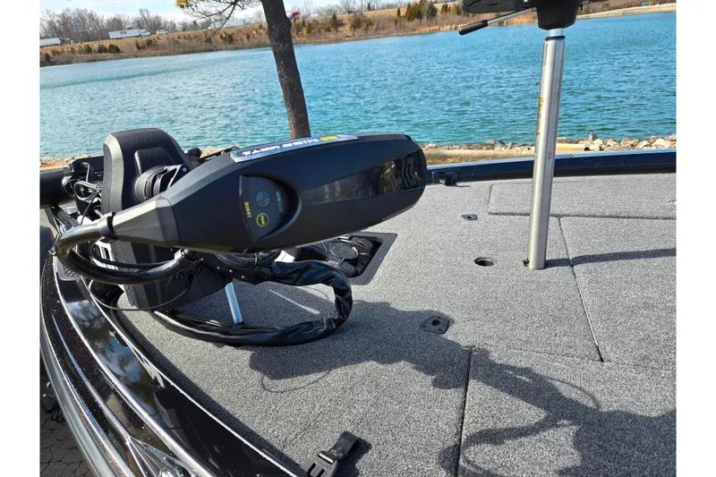 Slide: The Image of 2021 Ranger Z521L boat deck with trolling motor by a scenic lake. - 9