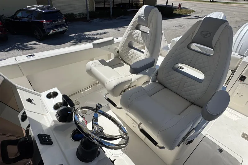 Slide: The Image of 2026 Sailfish 272 CC boat cockpit with luxurious seating and modern steering wheel. - 11