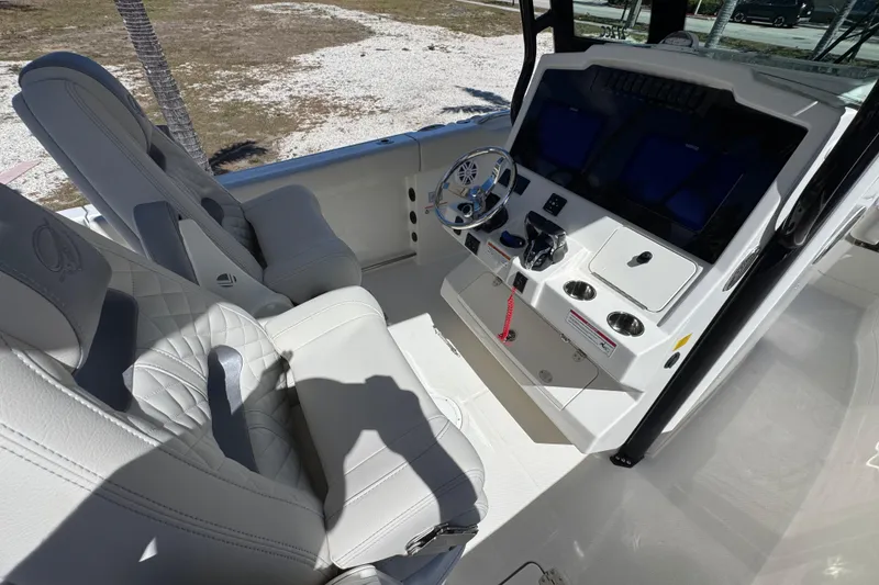 Slide: The Image of 2026 Sailfish 272 CC boat interior with modern helm and comfortable seating. - 12