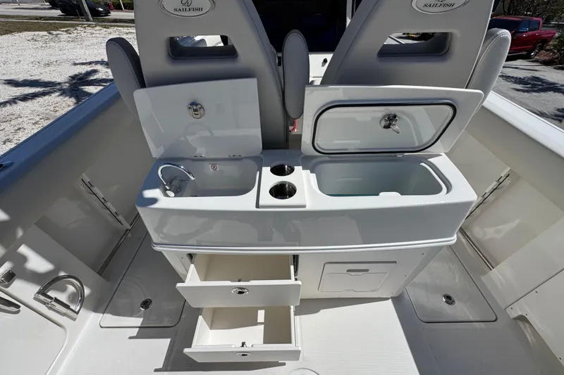 Slide: The Image of 2026 Sailfish 272 CC boat interior with sink, storage, and cup holders. - 14