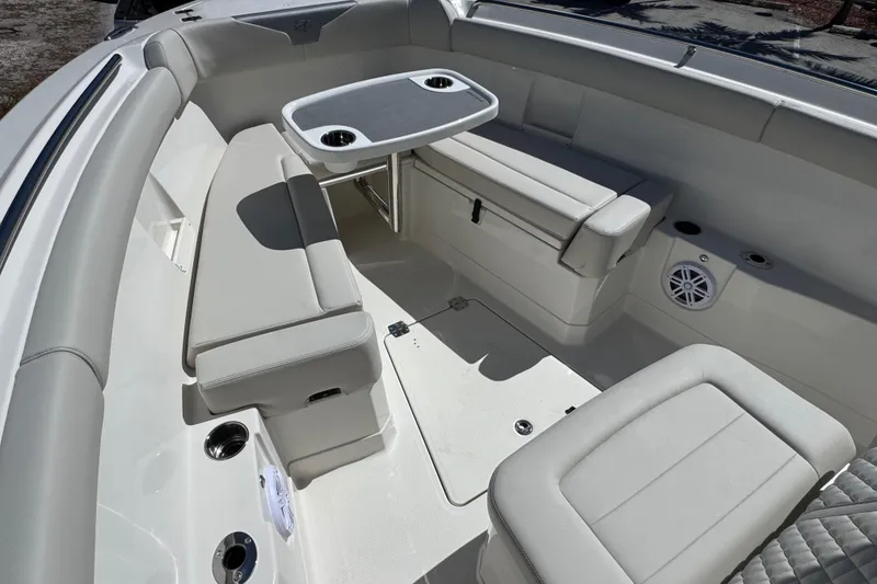 Slide: The Image of 2026 Sailfish 272 CC boat interior with cushioned seating and table. - 17