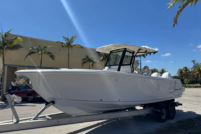 Slide: The Image of 2026 Sailfish 272 CC boat on trailer under clear blue sky. - 2