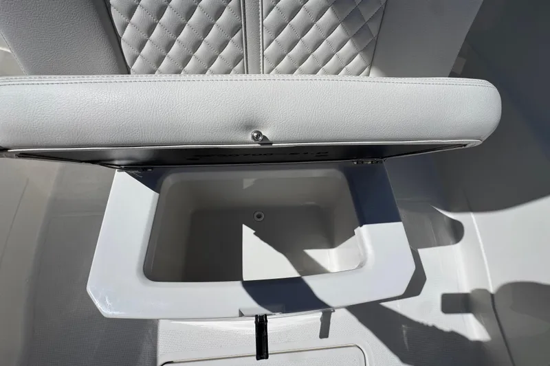 Slide: The Image of Open storage compartment on 2026 Sailfish 272 CC boat with quilted seat design. - 21