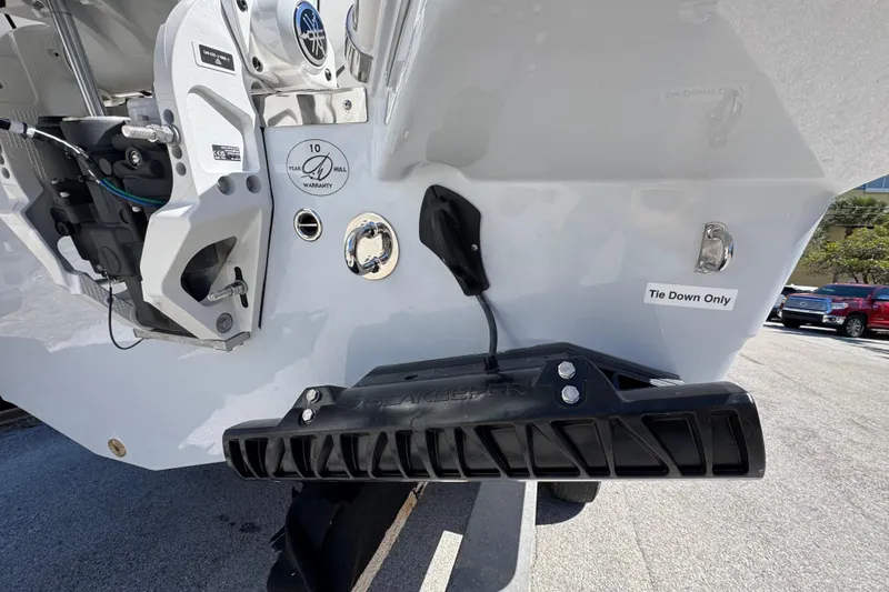 Slide: The Image of 2026 Sailfish 272 CC boat stern with warranty label and tie-down instructions. - 22