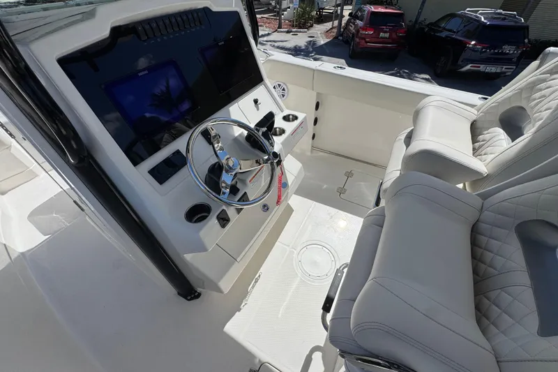 Slide: The Image of 2026 Sailfish 272 CC boat interior with steering wheel and plush seating. - 7