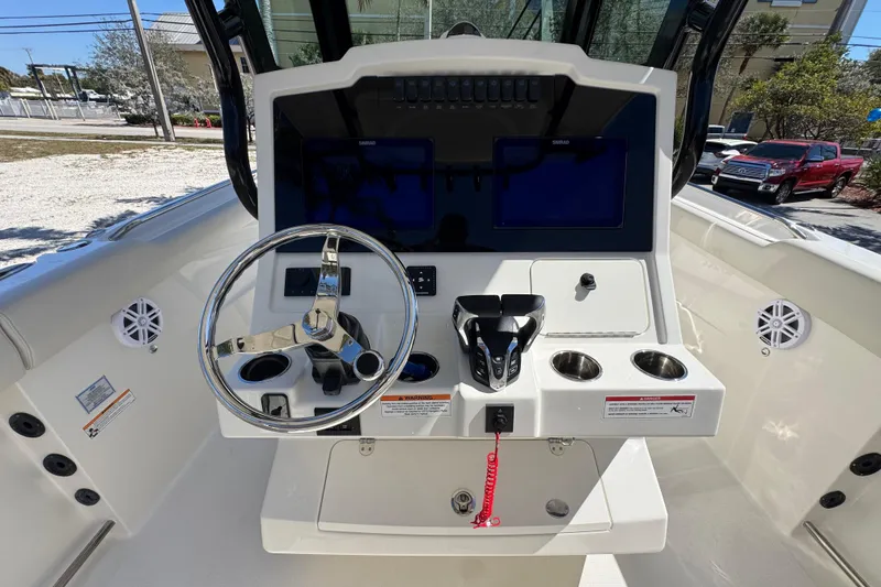 Slide: The Image of 2026 Sailfish 272 CC boat dashboard with steering wheel and control panel. - 8