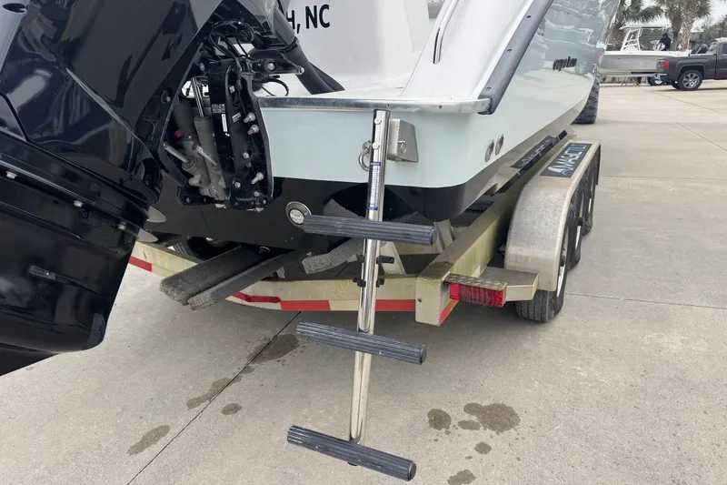 Slide: The Image of 2024 Cape Horn 32 XS boat on trailer with ladder and outboard motor. - 20