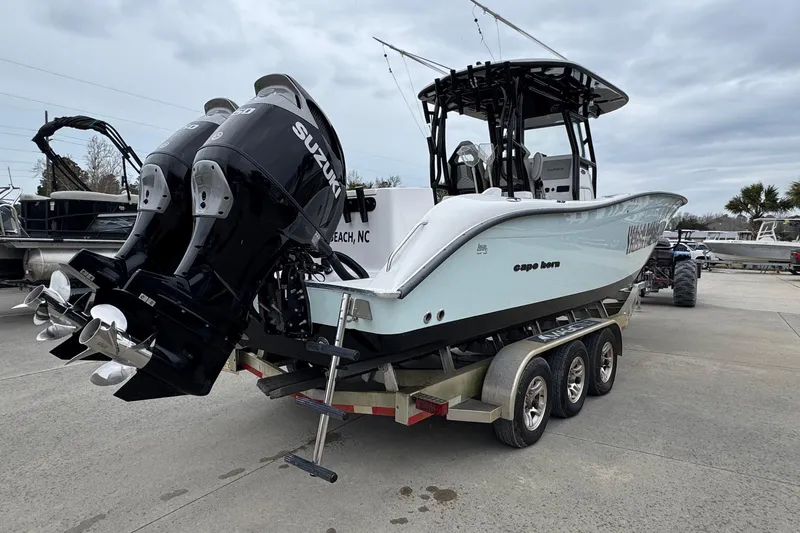 Slide: The Image of 2024 Cape Horn 32 XS boat with dual Suzuki engines on a trailer. - 4