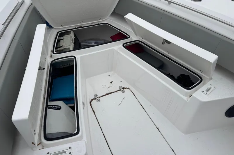 Slide: The Image of 2024 Cape Horn 32 XS boat storage compartments open, showcasing interior space. - 7