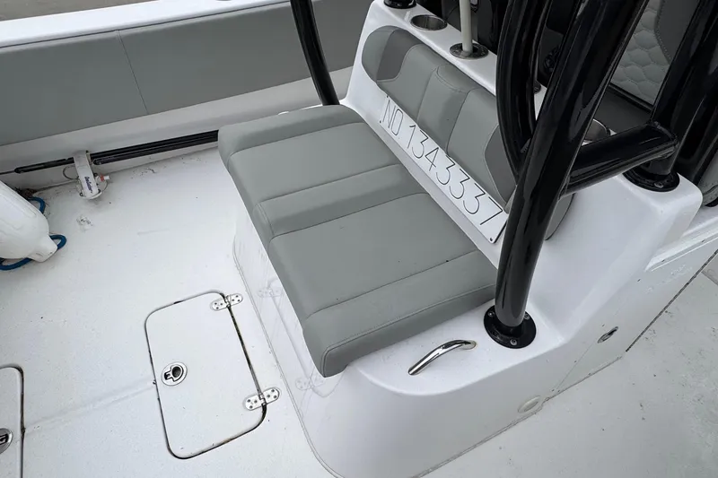 Slide: The Image of 2024 Cape Horn 32 XS boat interior with gray seating and storage compartments. - 12