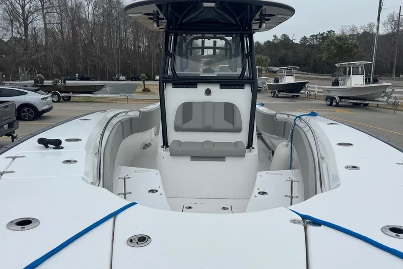 Slide: The Image of 2024 Cape Horn 32 XS boat with spacious seating and modern design at a marina. - 19