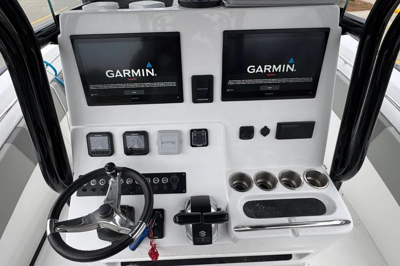 Slide: The Image of 2024 Cape Horn 32 XS boat console with Garmin displays and steering wheel. - 21