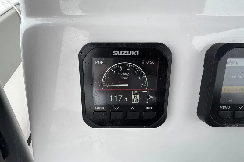 Slide: The Image of Suzuki engine display on 2024 Cape Horn 32 XS boat dashboard. - 22