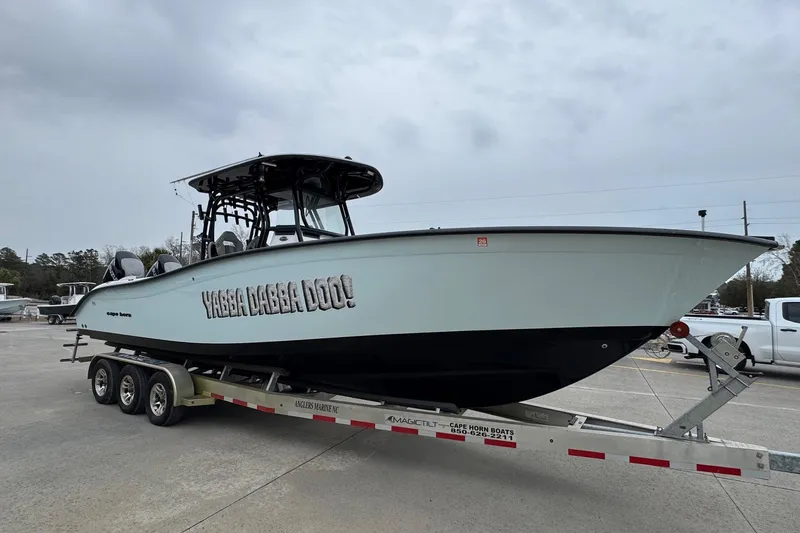 Slide: The Image of 2024 Cape Horn 32 XS boat on trailer, side view with "Yabba Dabba Doo!" text. - 3