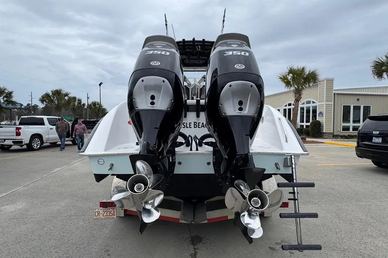 Slide: The Image of 2024 Cape Horn 32 XS boat with dual 350 horsepower engines, parked outdoors. - 5