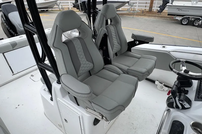 Slide: The Image of 2024 Cape Horn 32 XS boat interior with dual gray captain seats and steering wheel. - 8