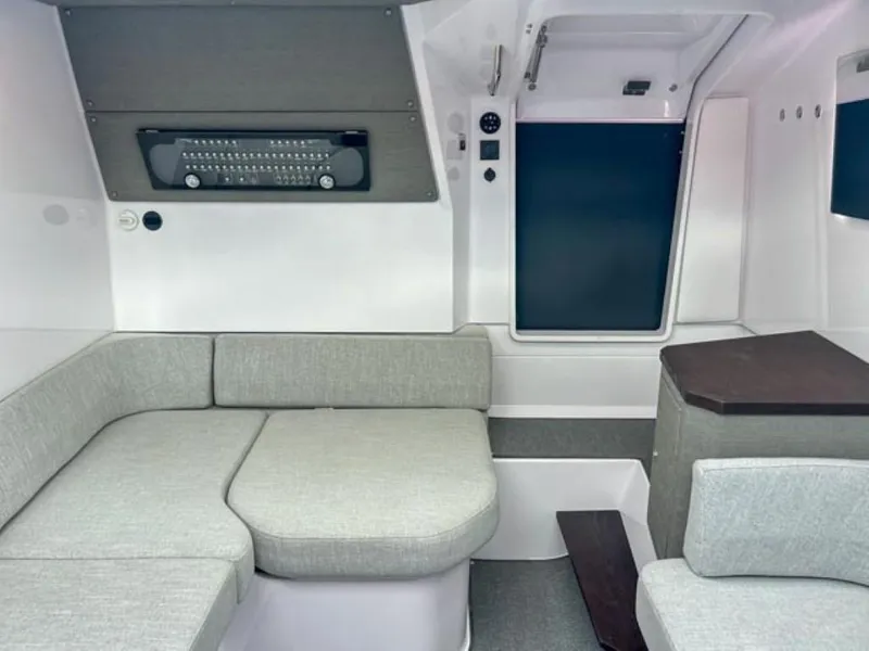 Slide: The Image of 2024 Axopar 37 Sun Top interior cabin with grey seating and modern design. - 13