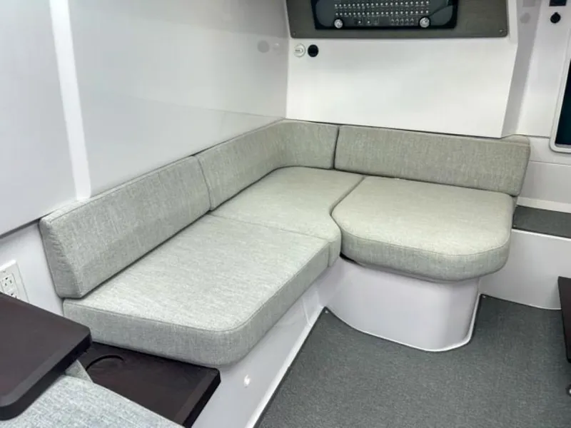 Slide: The Image of 2024 Axopar 37 Sun Top interior seating area with grey cushions. - 14