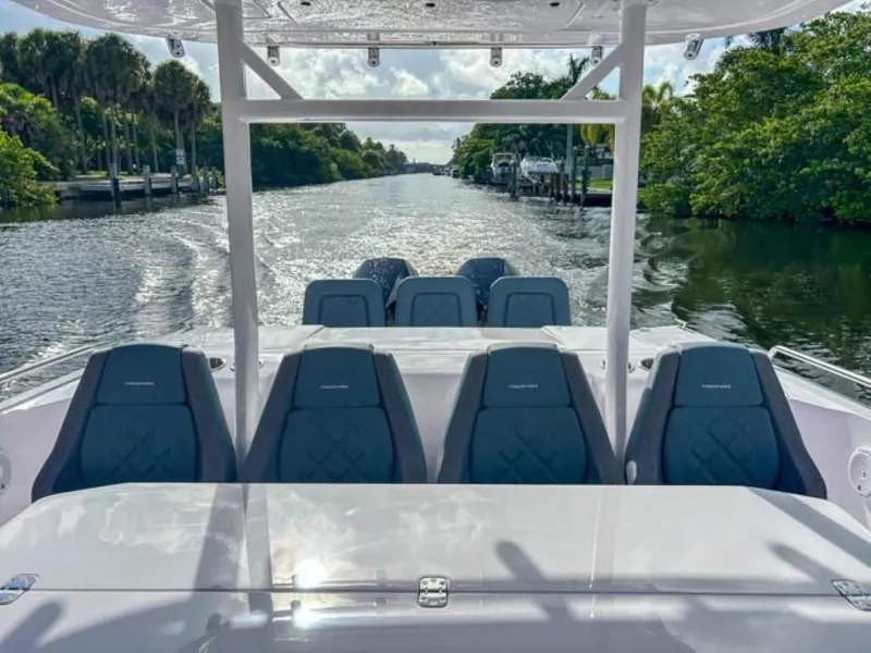 Slide: The Image of 2024 Axopar 37 Sun Top boat cruising on a scenic river. - 18