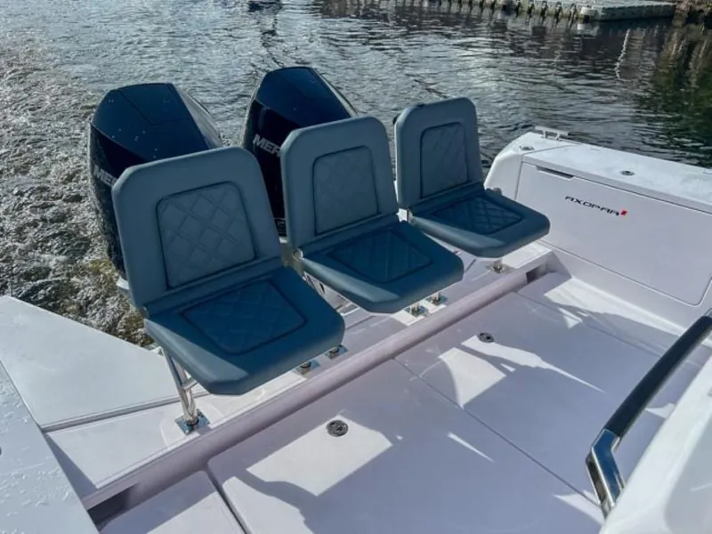Slide: The Image of 2024 Axopar 37 Sun Top boat with triple Mercury engines and rear seating. - 22