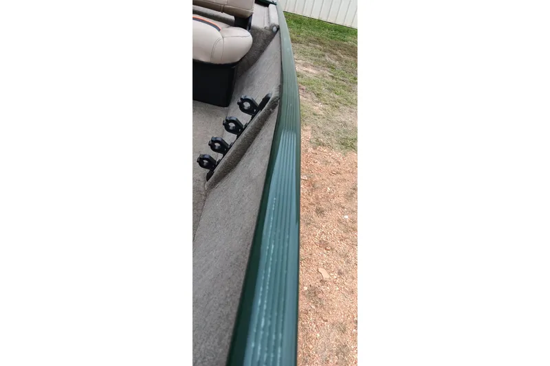 Slide: The Image of 2026 Tracker Bass Tracker Classic Limited boat interior with rod holders and seating. - 10