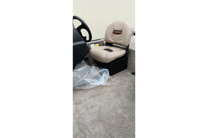Slide: The Image of 2026 Tracker Bass Tracker Classic Limited boat seat and steering wheel interior view. - 13