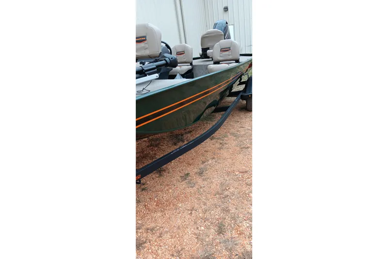 Slide: The Image of 2026 Tracker Bass Tracker Classic Limited boat on gravel, featuring sleek design and comfortable seating. - 16