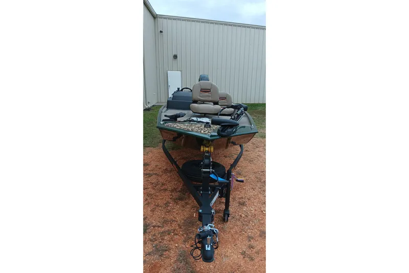 Slide: The Image of 2026 Tracker Bass Tracker Classic Limited boat on trailer near metal building. - 2