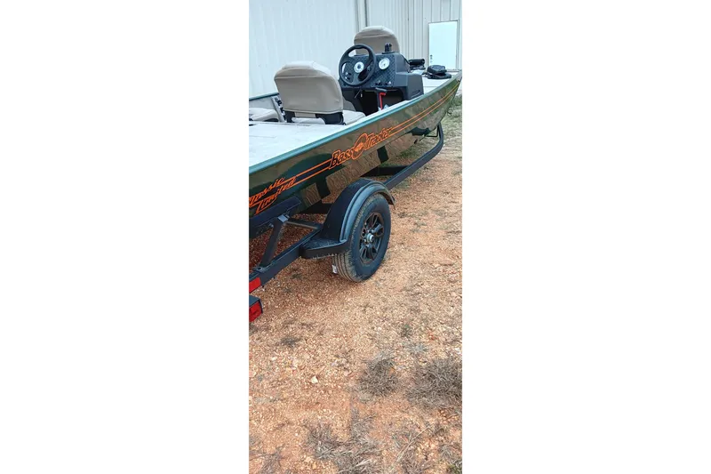 Slide: The Image of 2026 Tracker Bass Tracker Classic Limited boat on trailer, parked on gravel. - 4