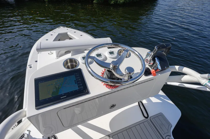 Slide: The Image of Helm of 2025 SeaVee 370Z boat with navigation display and controls on water. - 11