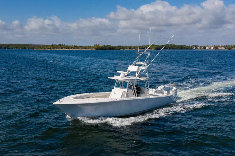 Slide: The Image of 2025 SeaVee 370Z boat cruising on open water under a partly cloudy sky. - 4