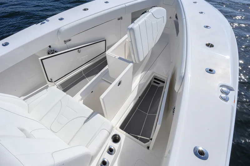 Slide: The Image of 2025 SeaVee 370Z boat interior with white seating and storage compartments. - 8
