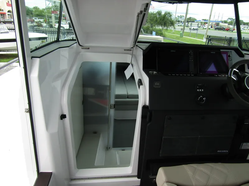 Slide: The Image of 2024 Axopar 37XC CROSS CABIN interior with modern helm and cabin access. - 25