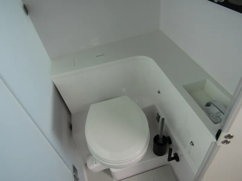 Slide: The Image of 2024 Axopar 37XC CROSS CABIN bathroom with modern white toilet and sleek design. - 26