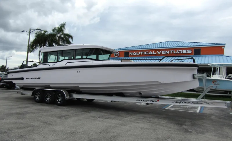 Slide: The Image of 2024 Axopar 37XC CROSS CABIN boat on trailer at Nautical Ventures dealership. - 5