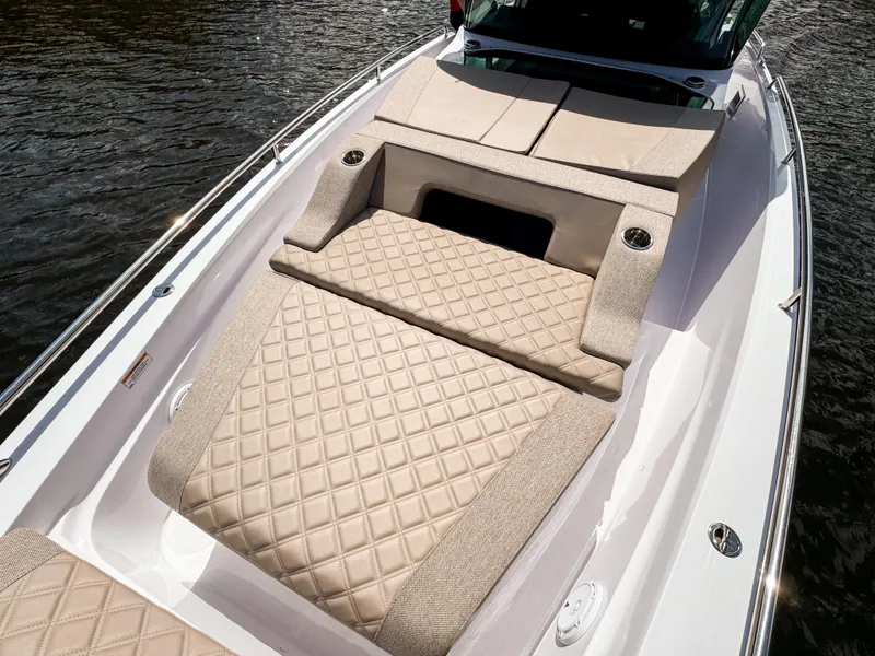 Slide: The Image of 2024 Axopar 37XC CROSS CABIN with luxurious beige diamond-stitched seating on deck. - 9