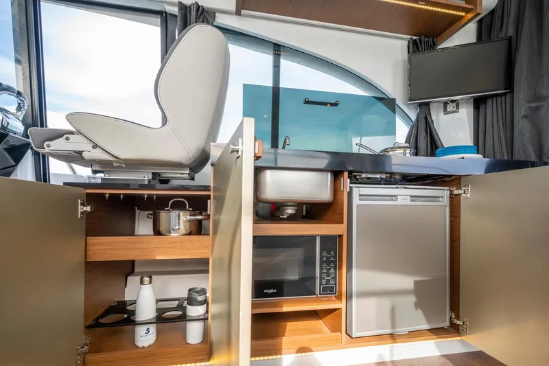 Slide: The Image of Modern kitchen interior of 2026 Beneteau Antares 11 yacht with appliances and storage. - 11