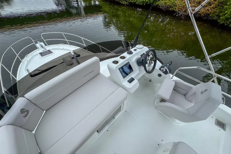 Slide: The Image of Interior of 2026 Beneteau Antares 11, featuring wood paneling and control panels. - 27