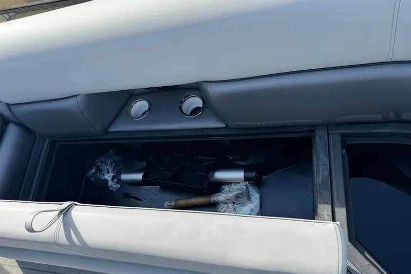 Slide: The Image of 2026 Bentley Pontoons Elite 253 Swingback storage compartment with dual captain seating. - 13