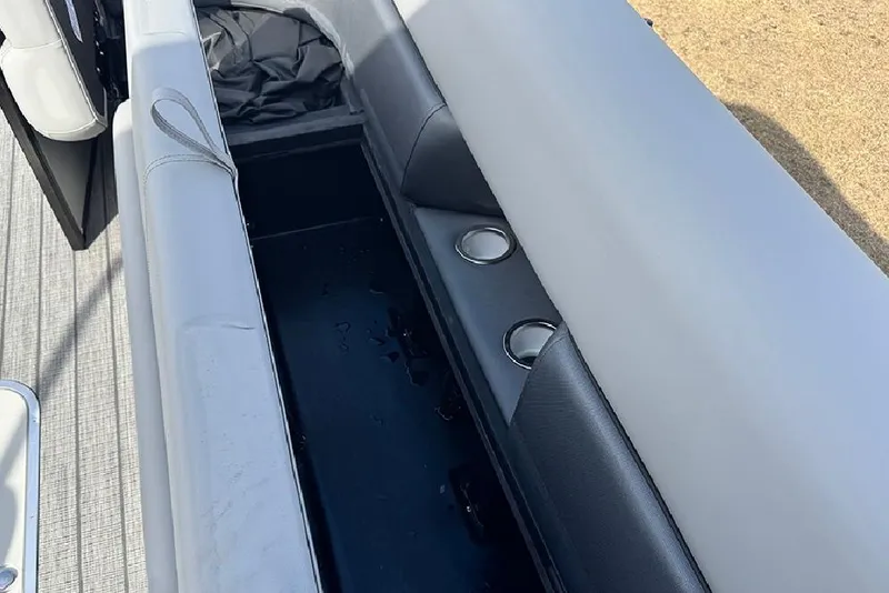 Slide: The Image of 2026 Bentley Pontoons Elite 253 Swingback interior storage and seating area. - 17