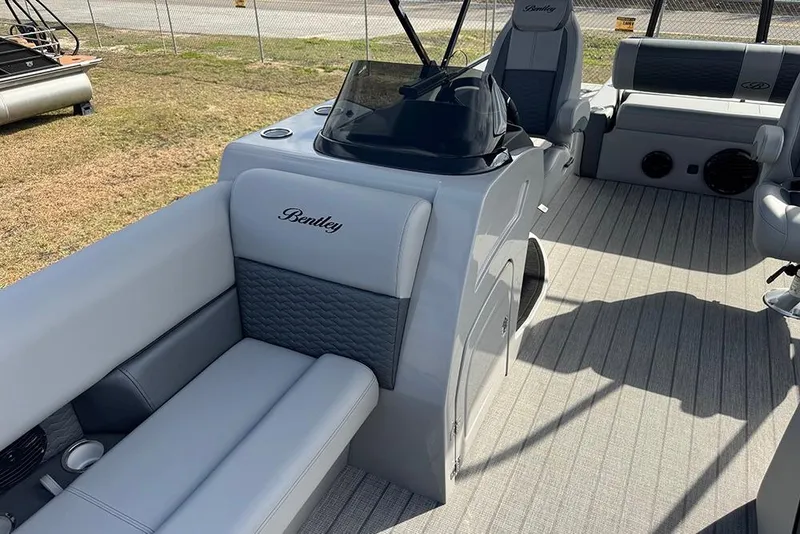 Slide: The Image of 2026 Bentley Pontoons Elite 253 Swingback Dual Captain Full Tritoon interior with luxurious seating and helm. - 20