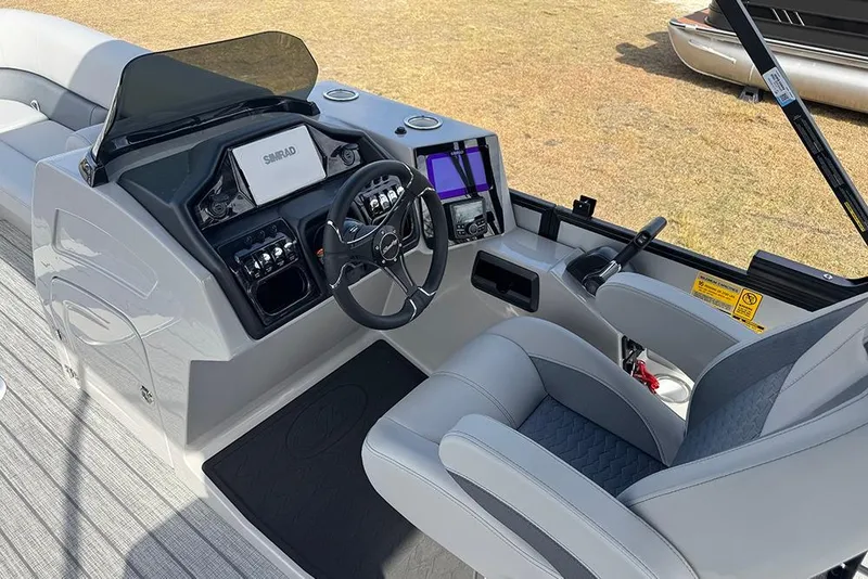 Slide: The Image of 2026 Bentley Pontoons Elite 253 Swingback Dual Captain Full Tritoon helm with modern controls and seating. - 22