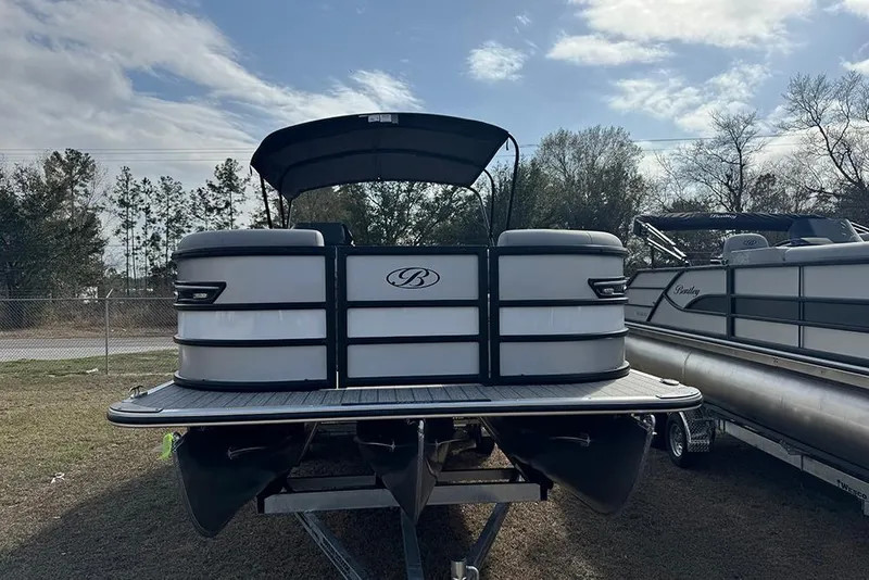 Slide: The Image of 2026 Bentley Pontoons Elite 253 Swingback Dual Captain Full Tritoon on display outdoors. - 4