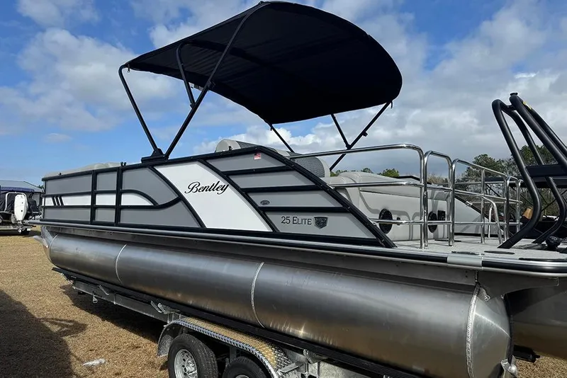 Slide: The Image of 2026 Bentley Pontoons Elite 253 Swingback Dual Captain Full Tritoon with canopy, on trailer. - 7