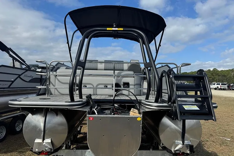 Slide: The Image of 2026 Bentley Pontoons Elite 253 Swingback Dual Captain Full Tritoon, rear view with ladder. - 9
